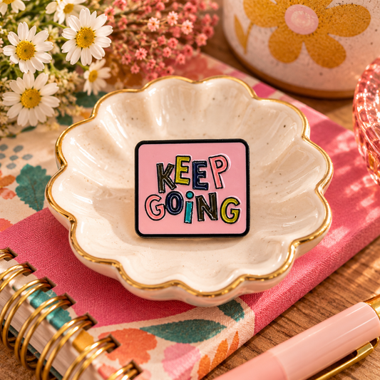 Keep Going pink colorful enamel pin styled hero image