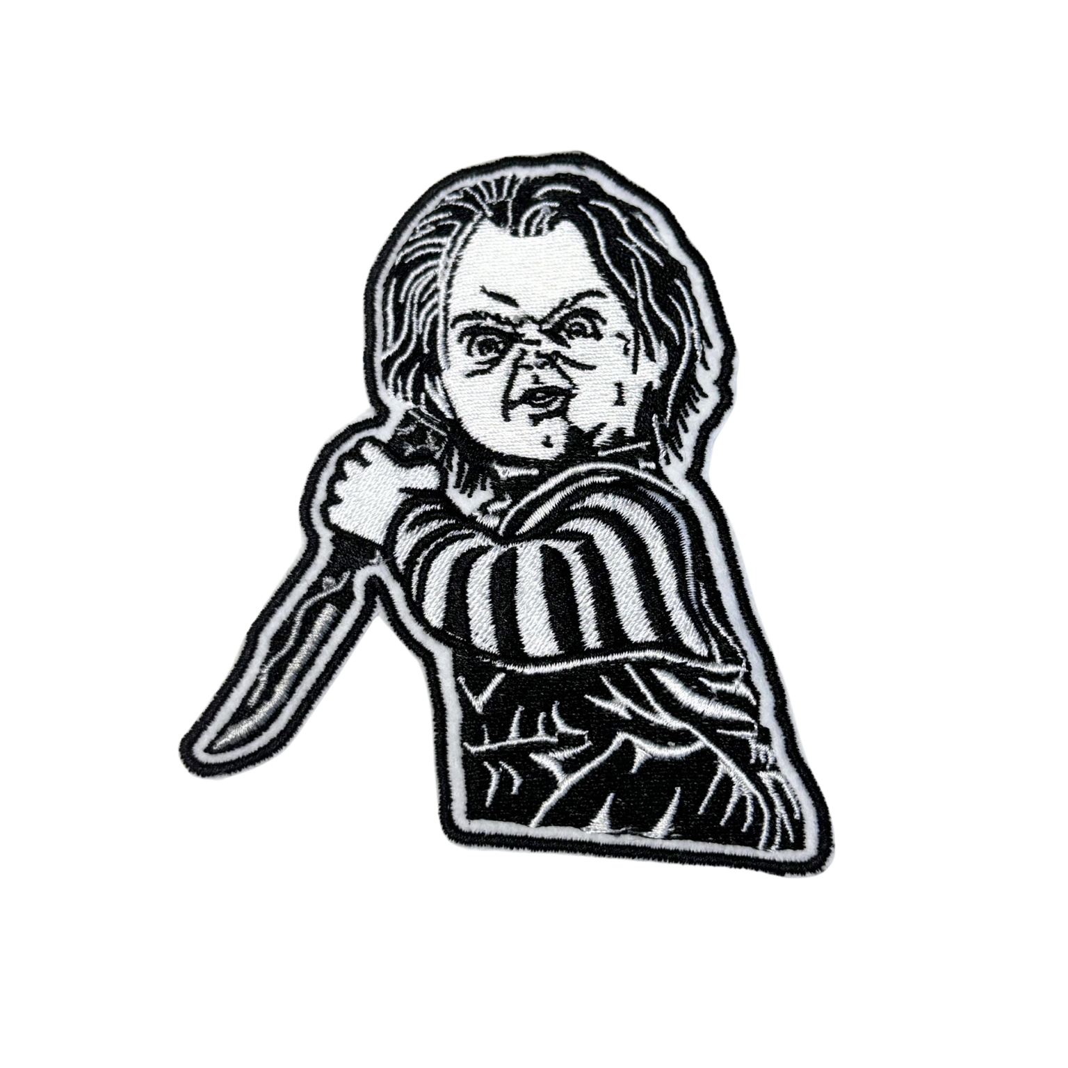Black and white embroidered killer doll patch with knife on white background
