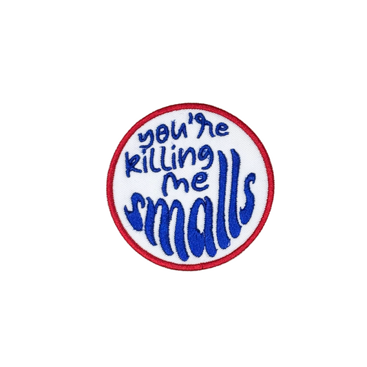 Close-up of “You're killing me Smalls” embroidered patch on white background
