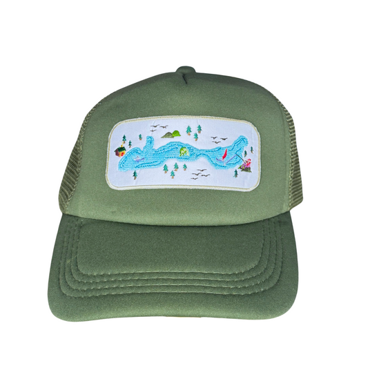 Green trucker hat with a scenic patch on a white background