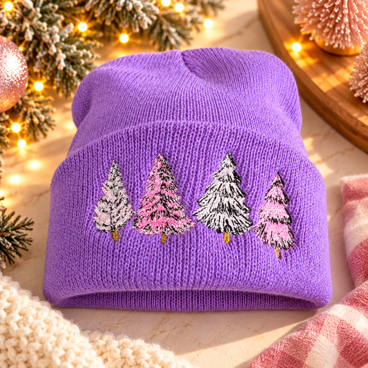 Lavender beanie with four pastel embroidered Christmas trees in a warm festive holiday setting