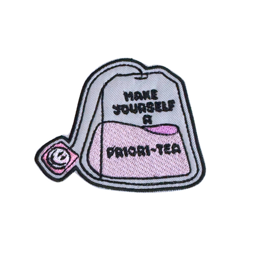 Embroidered iron-on patch featuring a teabag with the phrase "Make Yourself a Priori-Tea" in a playful font.
