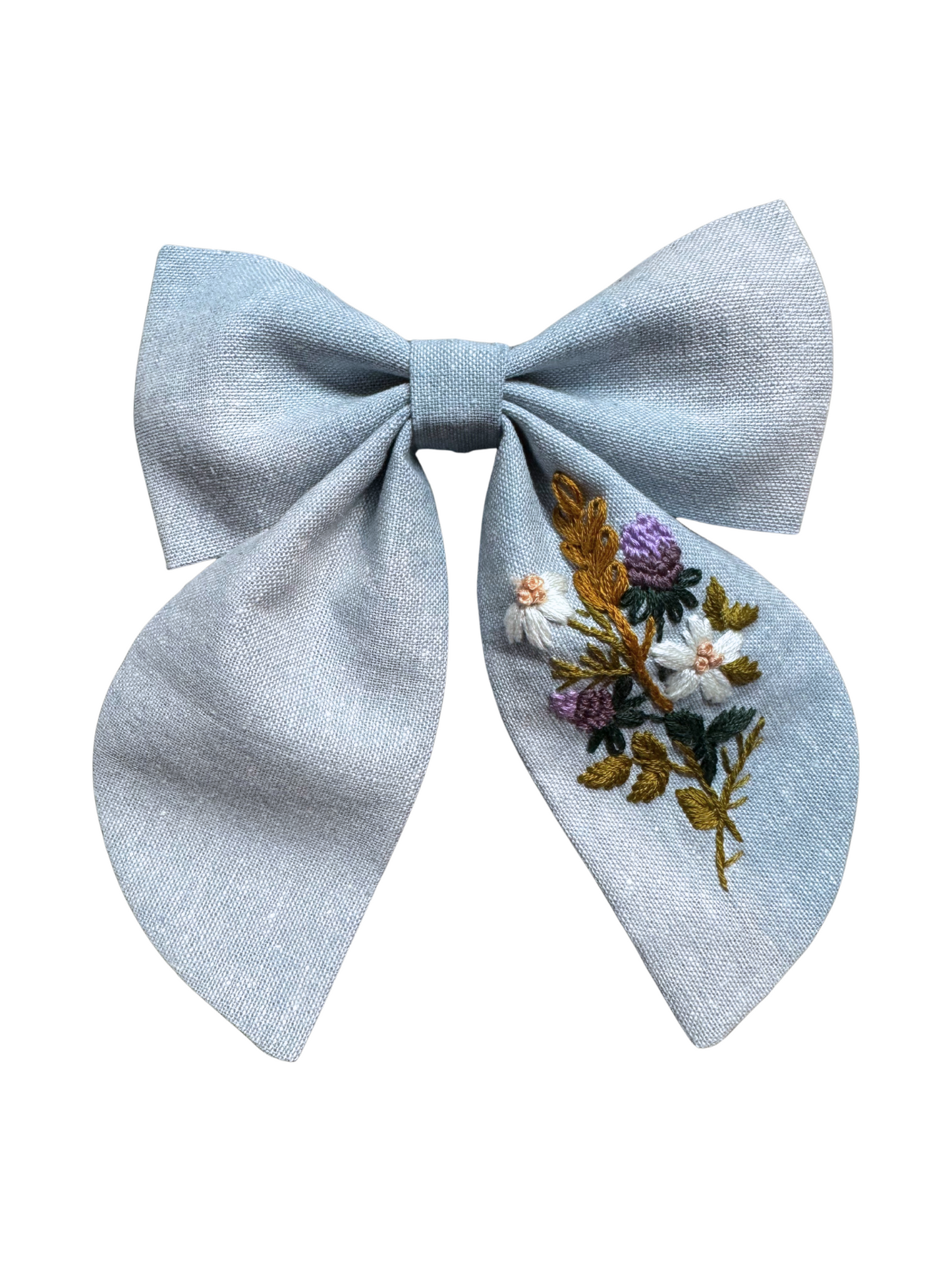 Light blue bow with floral embroidery on a white background