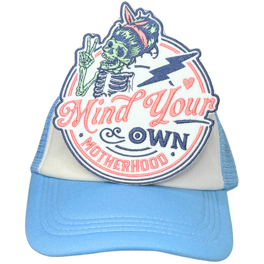 Bold embroidered motherhood patch ironed on white and blue trucker hat

