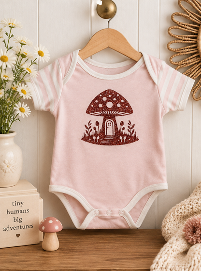 Pink mushroom baby onesie styled product photo