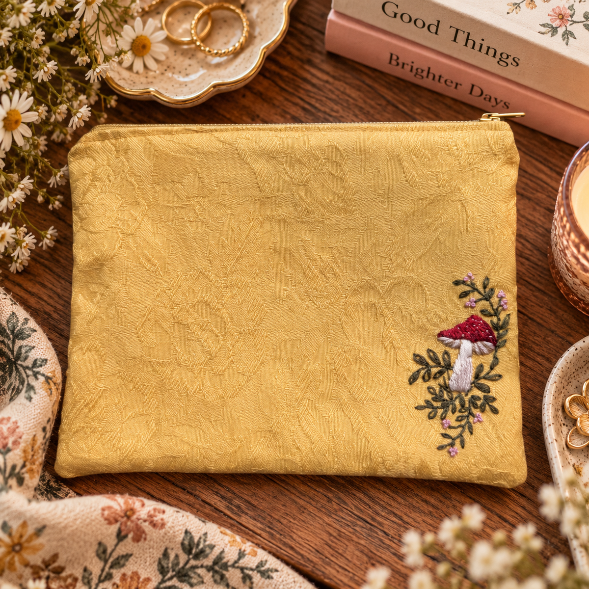 Hand-embroidered mushroom zipper clutch styled product photo