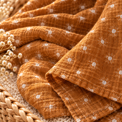 Mustard sunburst cotton gauze baby swaddle fabric texture and finished edge