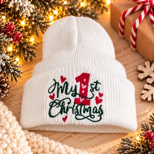 White baby beanie with “My 1st Christmas” embroidery styled for the holidays.