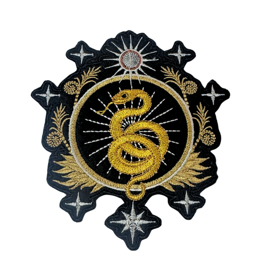 An embroidered patch featuring a gold snake coiled within a celestial black and gold design, symbolizing protection, wisdom, and rebirth.

