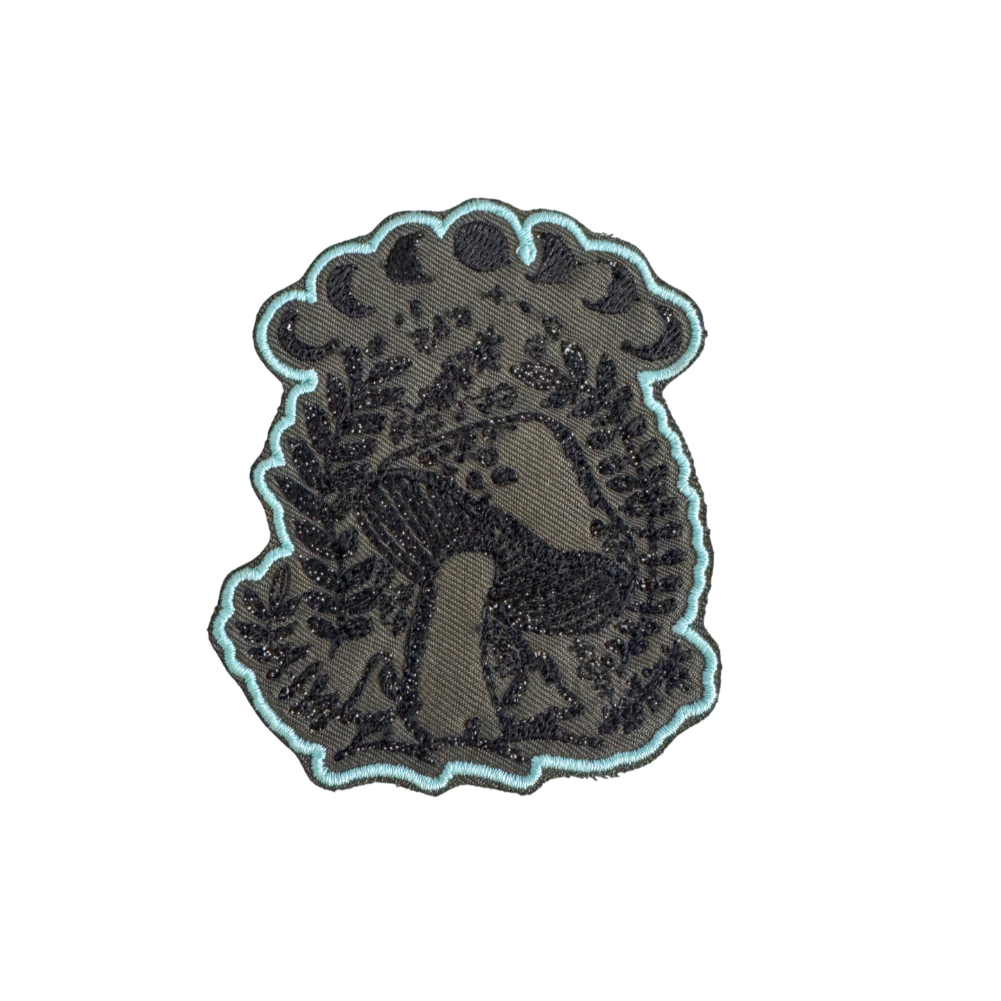 Handmade mystical mushroom embroidered patch with moon phases in black and teal tones.
