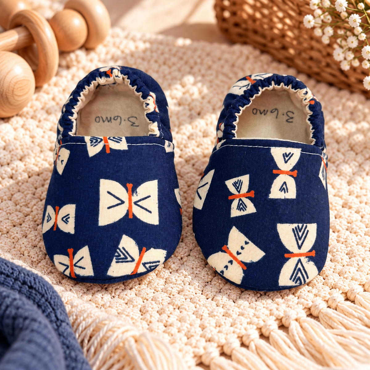 Navy butterfly soft sole baby moccasins, size 3–6 months