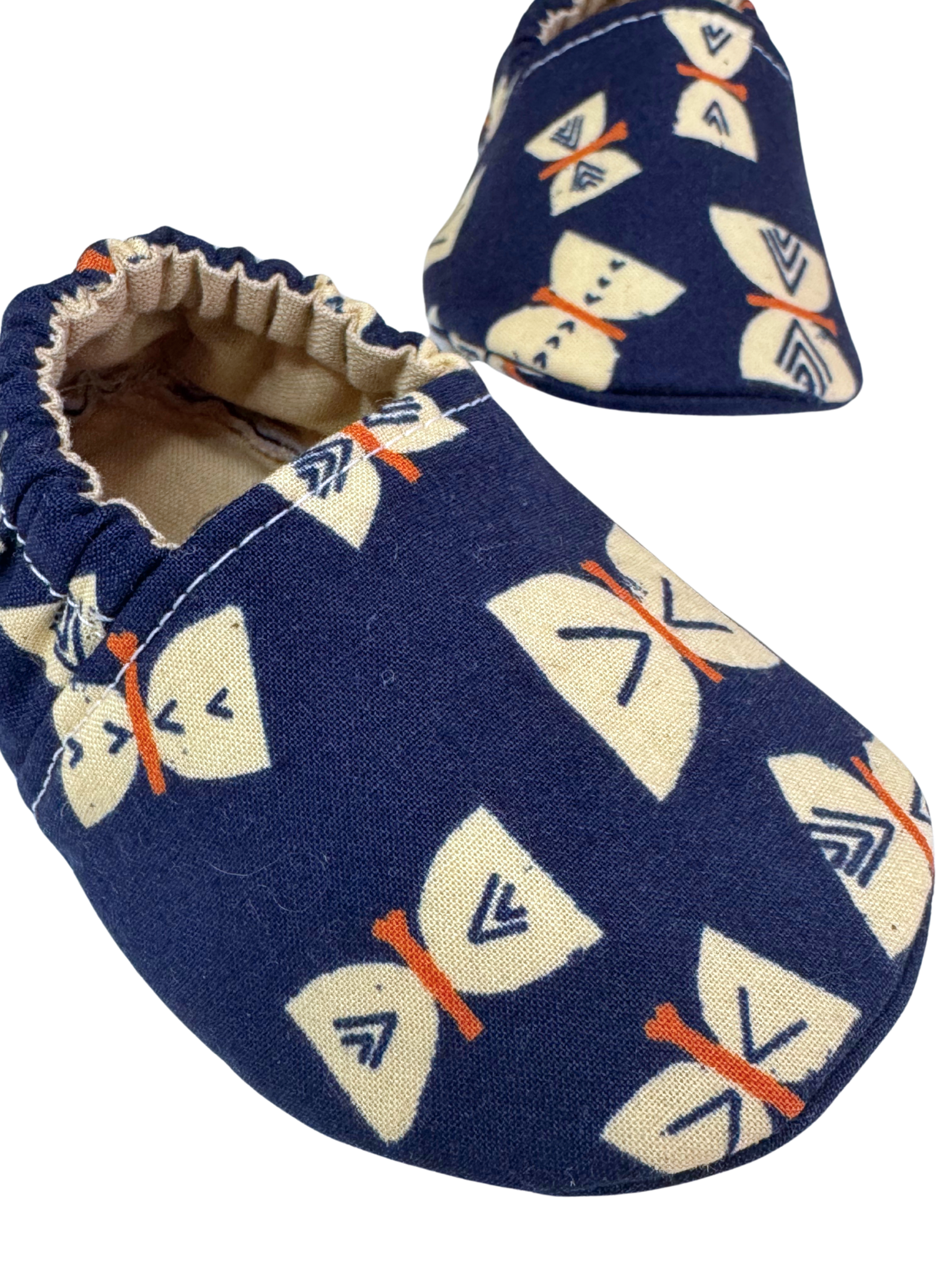 Closeup of butterfly pattern on soft sole baby shoes

