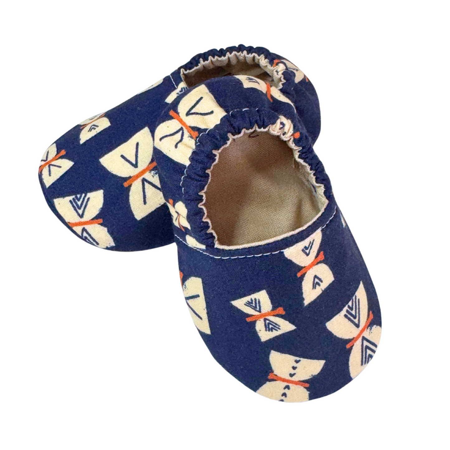 Side view of handmade butterfly baby moccasins in navy