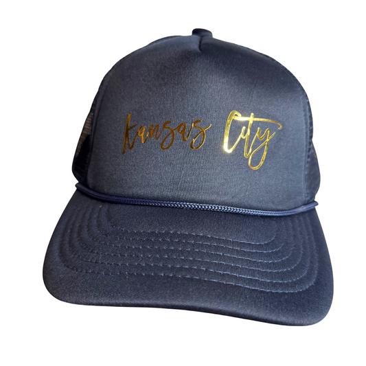 Navy blue cap with 'Kansas City' in gold on a white background
