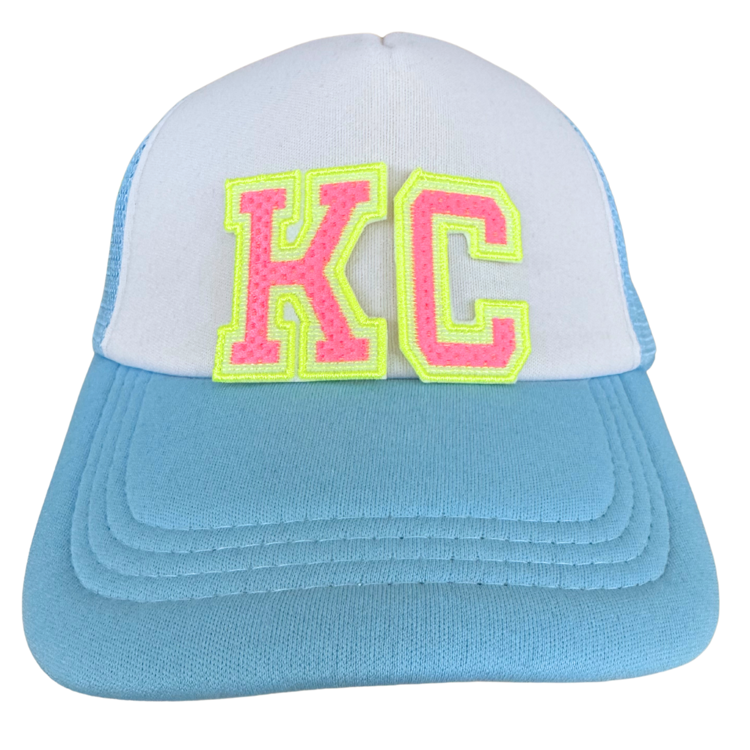 Trucker hat with bright pink and yellow “KC” varsity patch in chenille embroidery

