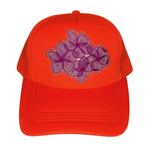 Orange cap with purple floral design on a white background
