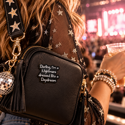 Nightmare Dressed Like a Daydream enamel pin on black concert bag lifestyle image