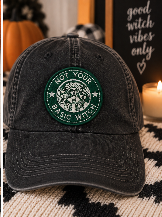 Not Your Basic Witch embroidered patch styled on a washed black dad hat