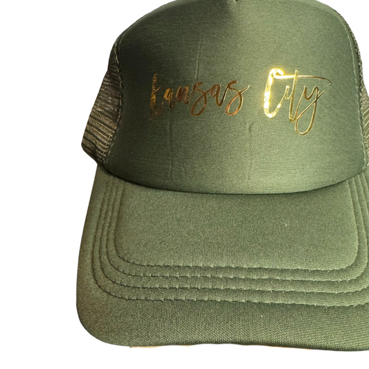 Green cap with gold text on a white background