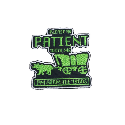 "Please Be Patient with Me, I'm from the 1900s" iron-on patch with neon green embroidery featuring a covered wagon inspired by the Oregon Trail game, handmade and ready to ship.

