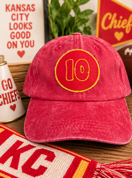 Vintage red Kansas City number 10 hat styled with red and gold football details