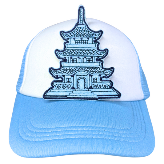 Blue pagoda embroidered patch attached to a light blue and white trucker hat.
