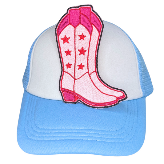 Pink western boot patch ironed on white and blue trucker hat

