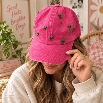 Woman wearing hand-embroidered pink hat with green bows
