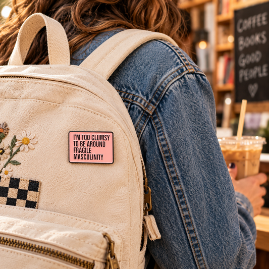Pink quote enamel pin on canvas backpack lifestyle image