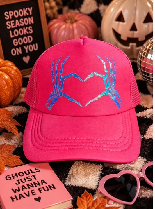 Neon pink skeleton heart hands trucker hat styled for Halloween