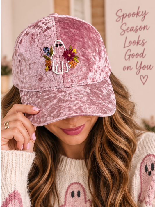 Model wearing hand-embroidered pink velvet floral ghost hat