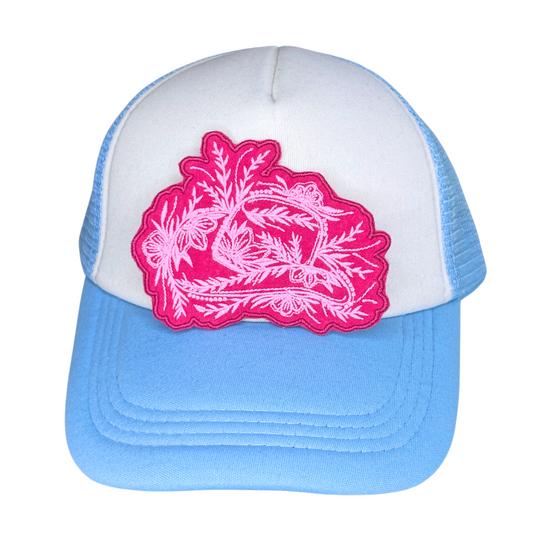 Blue and white trucker hat with pink floral cowboy hat patch

