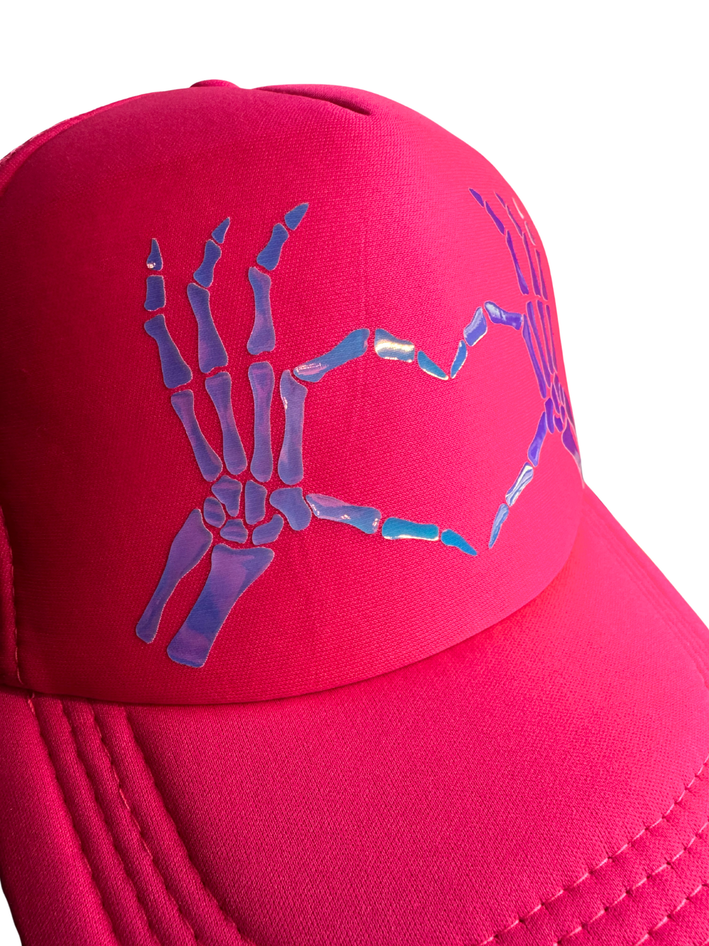 Pink cap with blue skeleton hand design on a white background