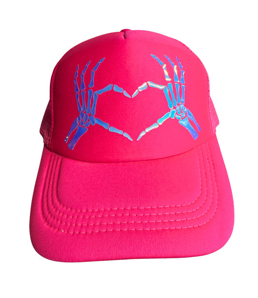 Pink cap with skeleton hands design on a white background