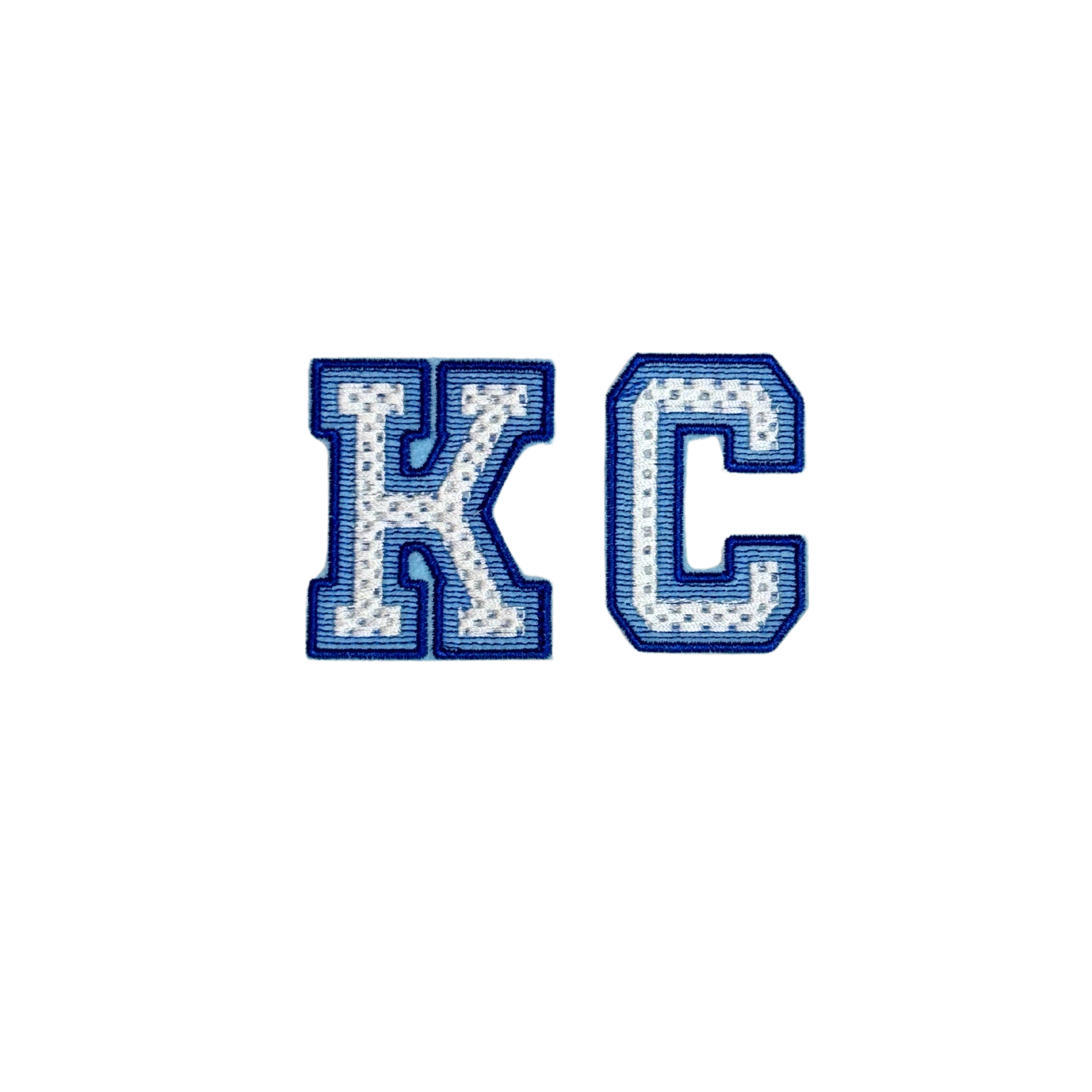 Closeup of embroidered white KC letters with royal blue outline patch inspired by Royals colors

