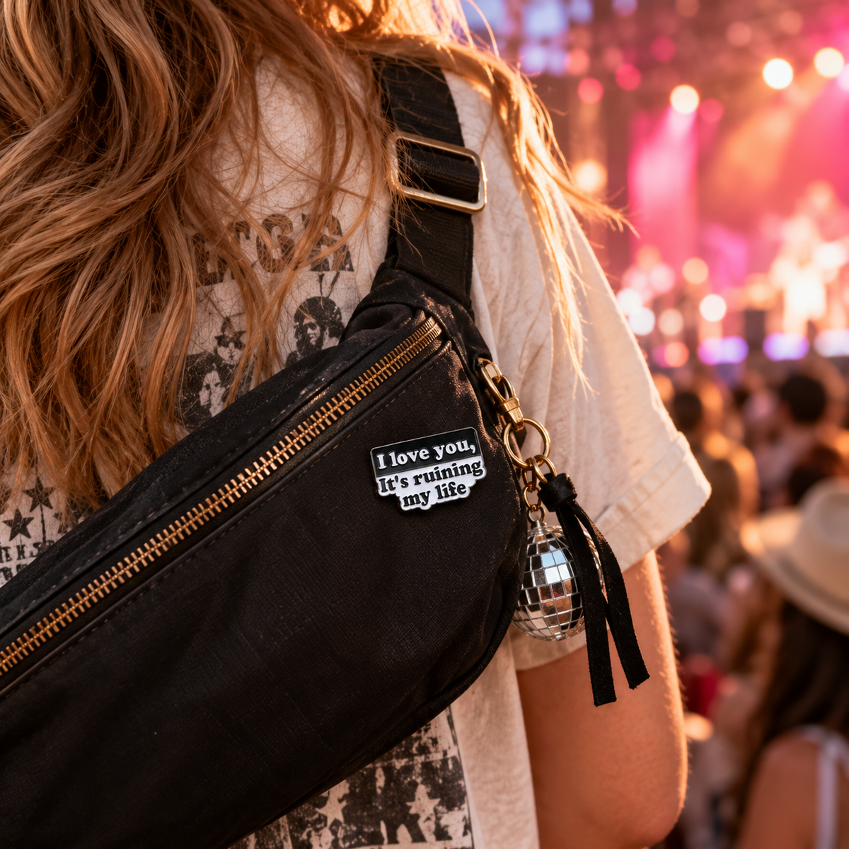 Black and white quote enamel pin on concert crossbody bag