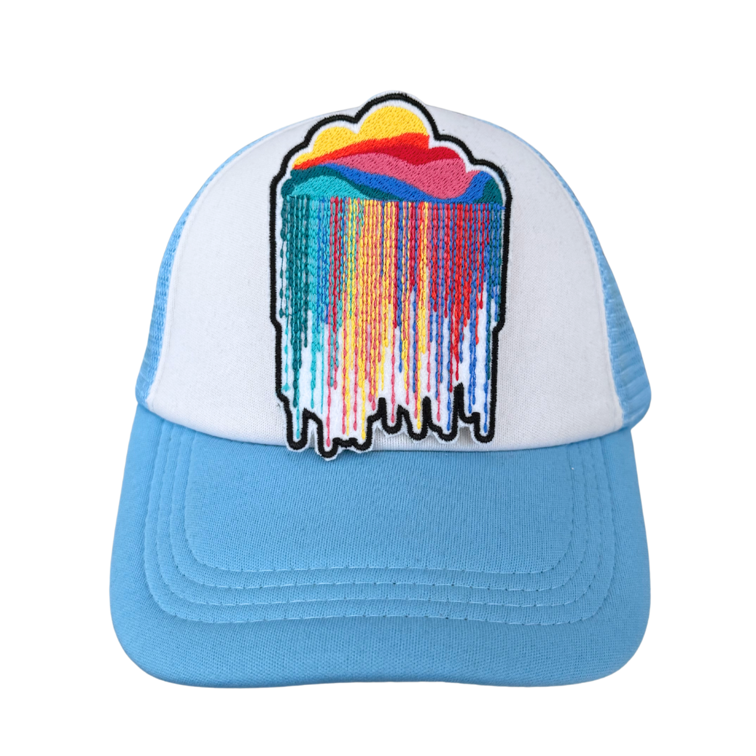 Rainbow cloud drip patch ironed onto white and blue trucker hat
