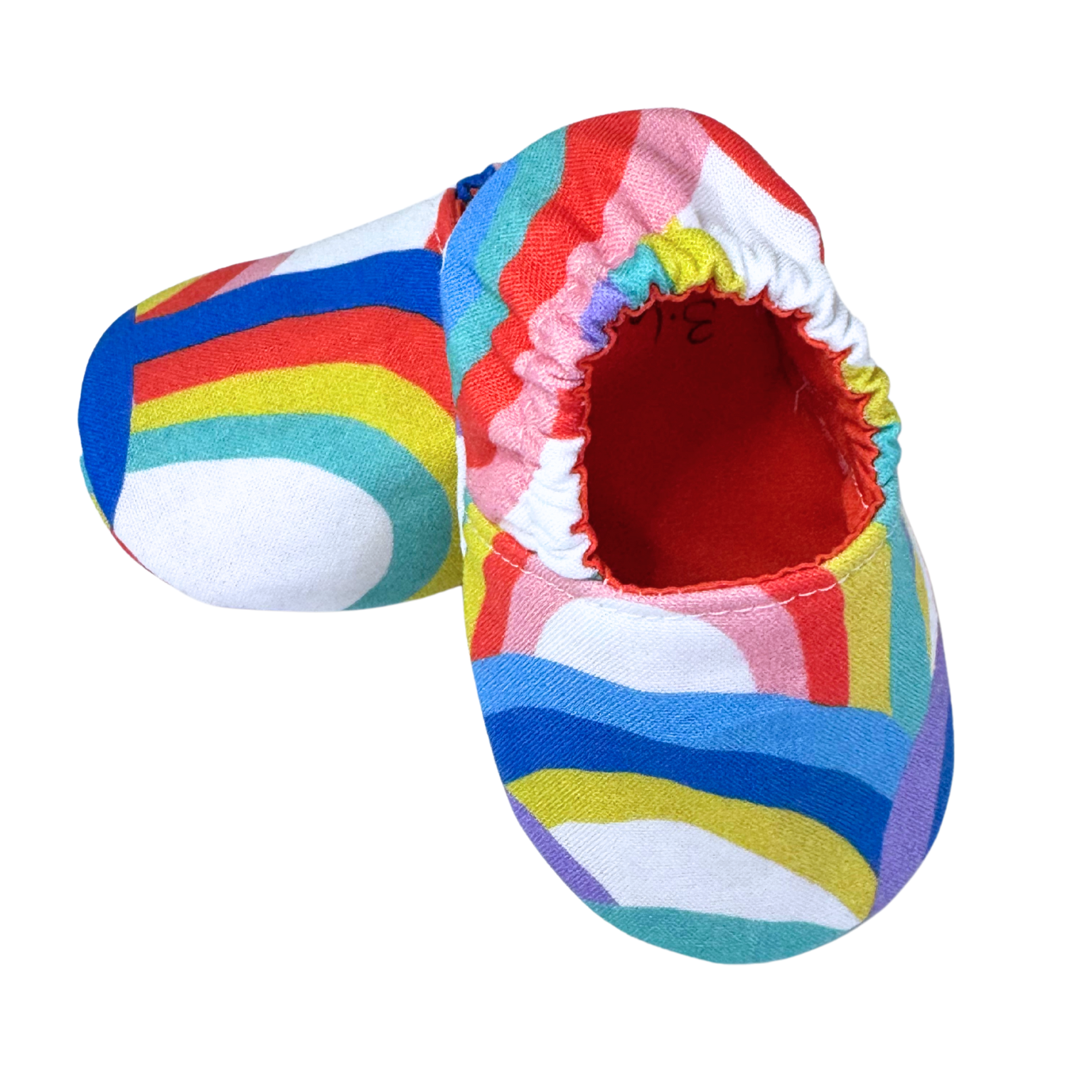 Side view of rainbow baby moccasins with red interior

