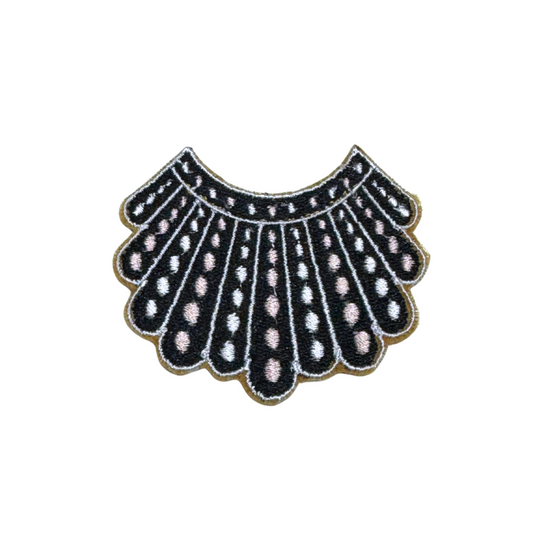 Embroidered patch featuring a black and white dissent collar with intricate details.

