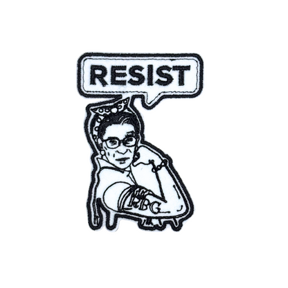 Close-up of an embroidered "Resist" patch featuring RBG in a Rosie the Riveter pose.
