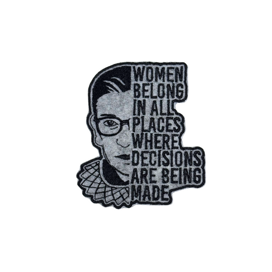 "Embroidered patch featuring Ruth Bader Ginsburg's face with the quote 'Women belong in all places where decisions are being made' in bold text."
