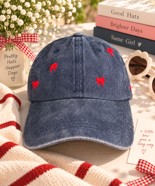Navy blue hand-embroidered red bow baseball hat styled with flowers and playful accessories