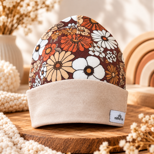 Retro floral organic cotton baby beanie with beige cuff, styled hero photo