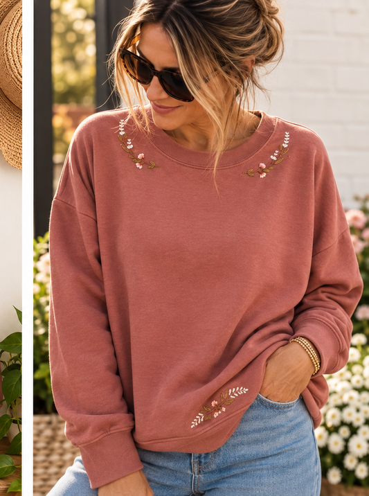 Model wearing hand-embroidered rose pink floral sweatshirt