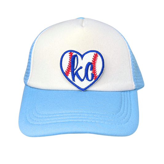 Trucker hat in white and light blue featuring a heart-shaped KC baseball patch in Royals colors

