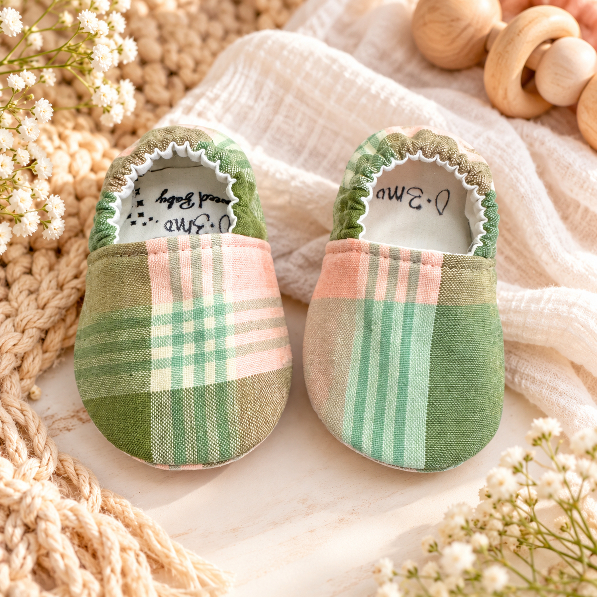 Sage plaid soft sole baby moccasins in green, blush and cream, size 0–3 months