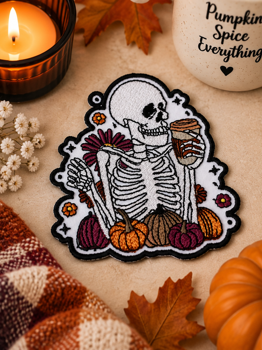 Skeleton Fall Vibes embroidered patch styled with pumpkins, candlelight and pumpkin spice coffee