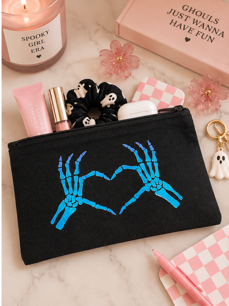 Black Skeleton Heart Hands zip pouch holding makeup and everyday essentials