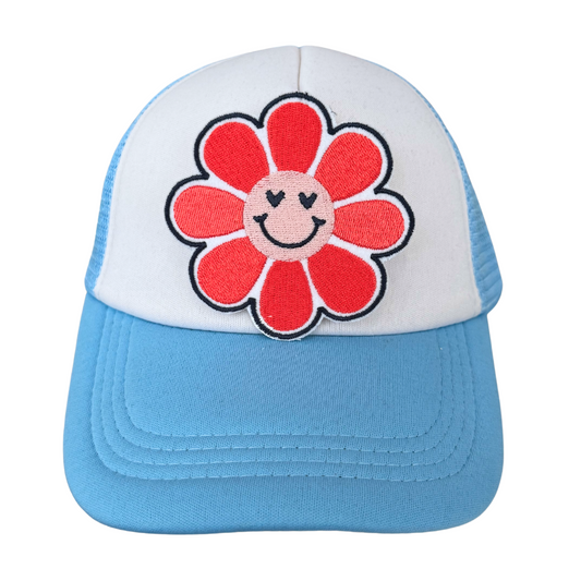 Smiley flower embroidered patch heat pressed on white and blue trucker hat
