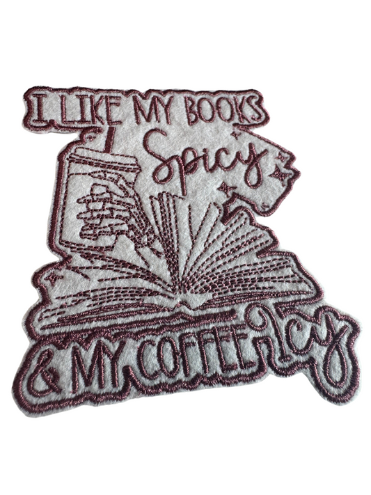 Close-up of spicy book lover patch with burgundy embroidery and iced coffee detail

